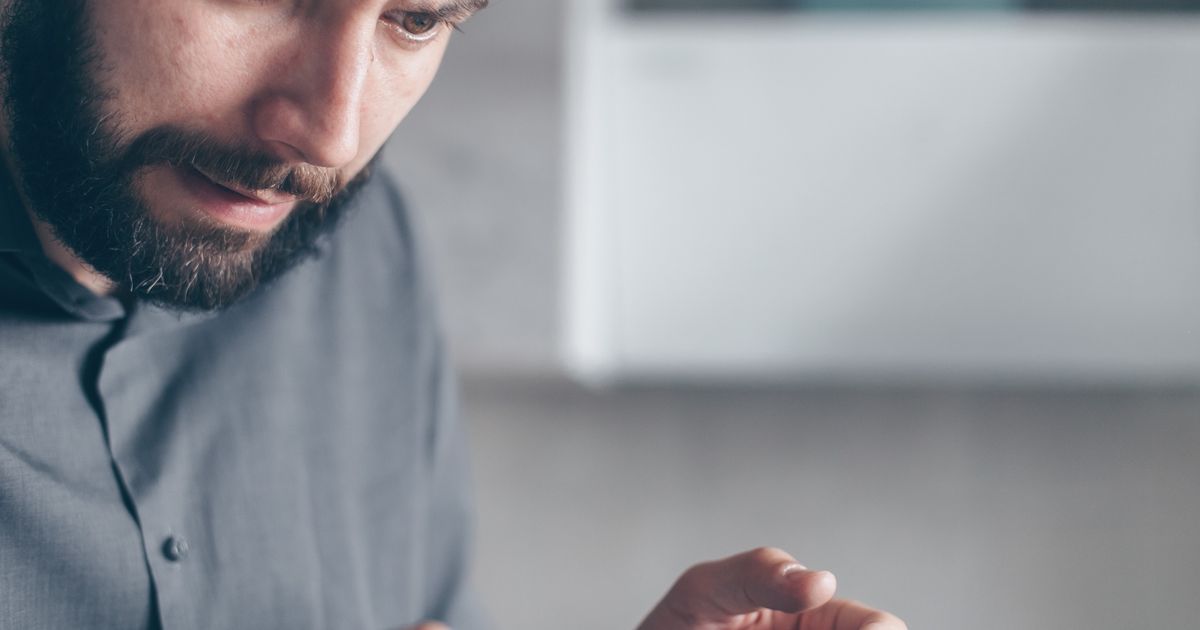 Man looking shocked while holding a smartphone